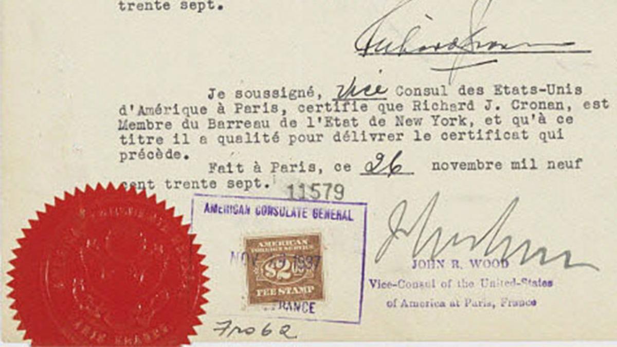 Document officiel dactylographié et signé à la main à l'encre noire. Le document porte un tampon bleu du consulat américain et un gros sceau rouge, en bas à gauche. 