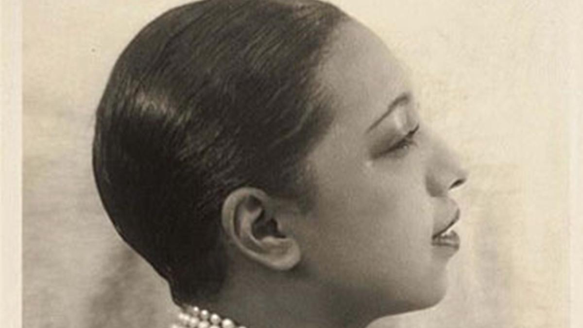 Photo en noir et blanc, en plan serré sur le visage de Joséphine Baker qui est de profil. Elle a les cheveux tr-s courts et gomminés. 