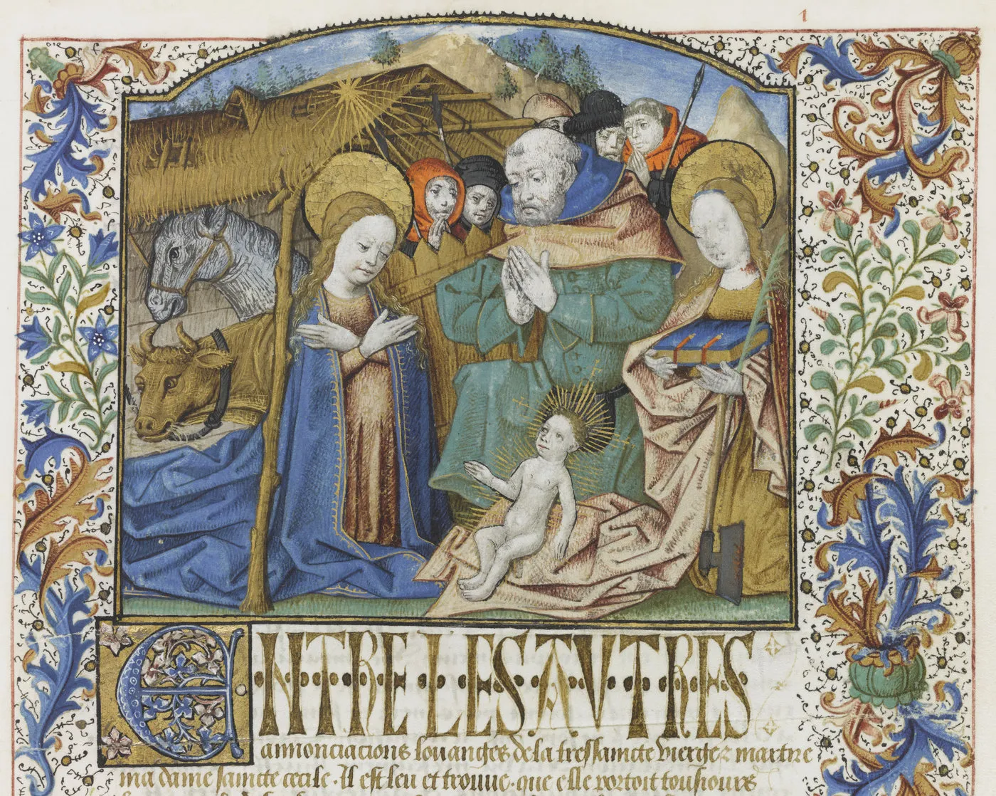 Détail d’une enluminure : Nativité entourée de personnages et d’animaux, encadrée de bordures végétales. Vue de face.