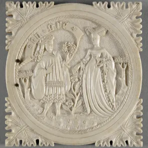 Square carved ivory plaque. The corners are adorned with leaves. At the center, a scene depicting a man and a woman within a circular medallion.