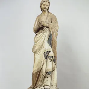 Wooden sculpture depicting a standing angel. Traces of polychromy. Front view on a neutral background.