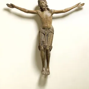 Polychrome wooden sculpture depicting Christ on the cross. Front view.