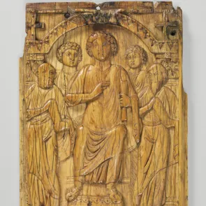 Carved ivory plaque: a seated man surrounded by figures above a cross between two angels. Front view.