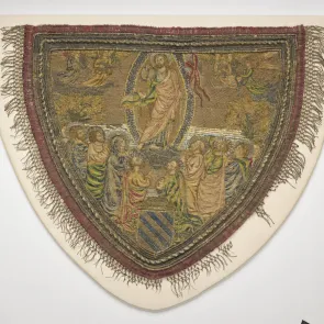 Embroidered hood edged with fringes, depicting a scene of the Ascension. Front view.