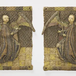Two embroidered squares, each depicting a kneeling angel in profile holding an object in hand. Front view.