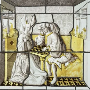 Rectangular yellow and gray stained glass window depicting a couple playing chess indoors. Front view.