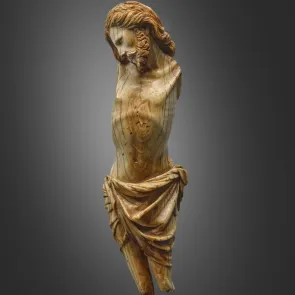 Lacunar ivory statuette depicting Christ with His head resting on His right shoulder. Front view.
