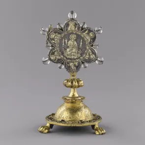 Gilded metalwork piece adorned with engraved patterns and crystal beads. Front view.