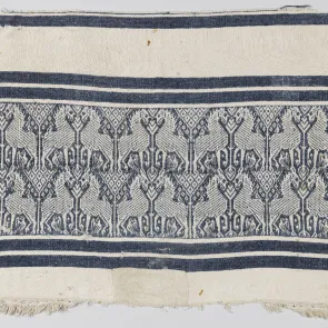 White fabric with blue stripes and blue-and-white patterns of unicorns facing each other. Front view.