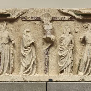 Carved stone altarpiece with traces of polychromy: Crucifixion framed by multiple figures. Front view.