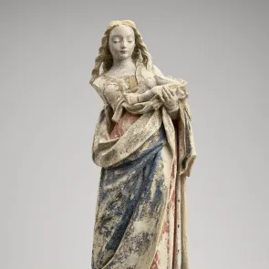 Stone statue of the Virgin and Child with traces of polychromy. Full-length view on a neutral background.