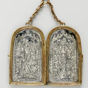 Metal object with two engraved panels: one depicting a woman holding a lit candle, and the other a woman with a sword. Front view.