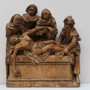 Wooden sculpture depicting a man carried above a tomb by four figures. Front view.