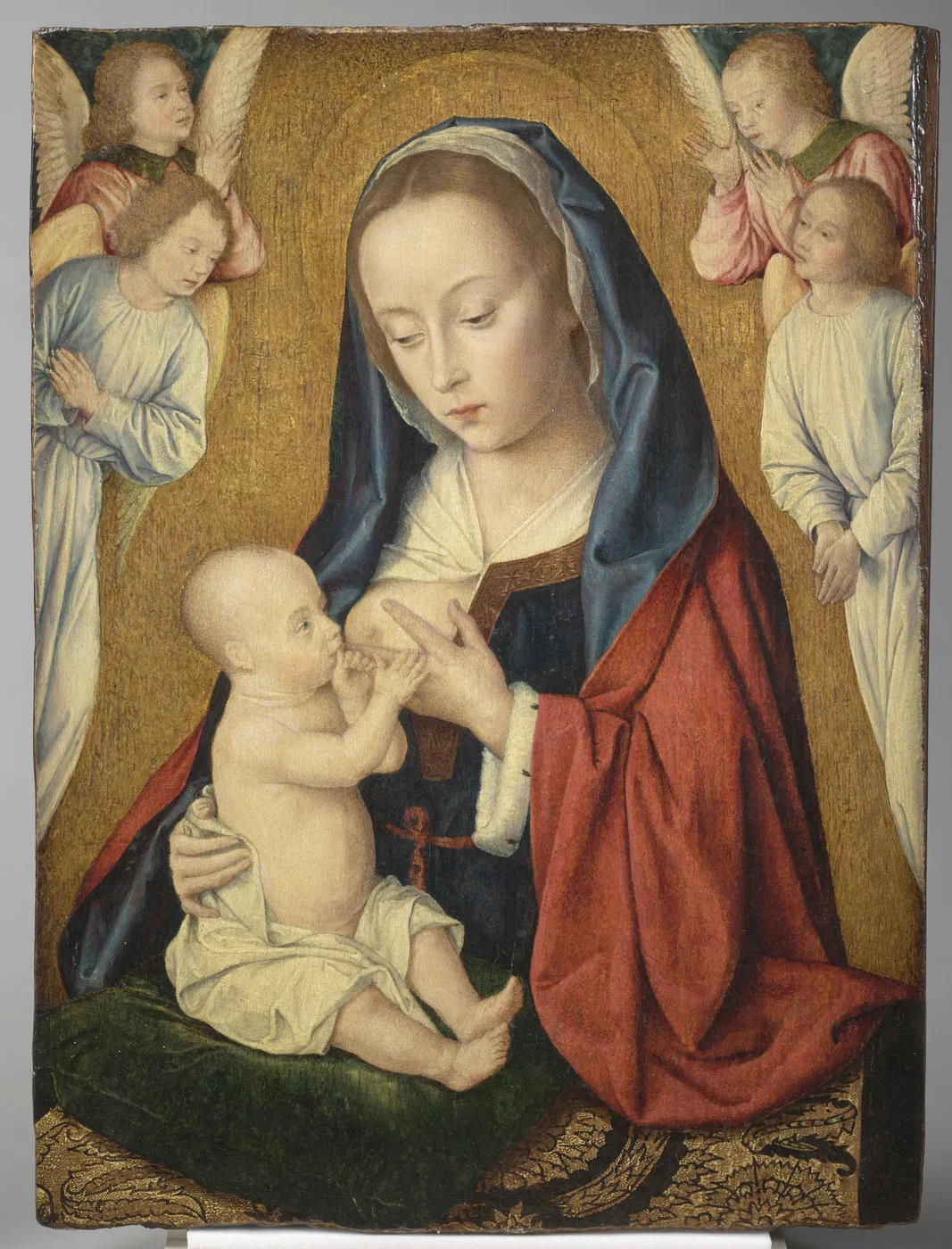 Tableau peint représentant une Vierge donnant le sein à l'Enfant Jésus et entourée d'anges. Vue de face.