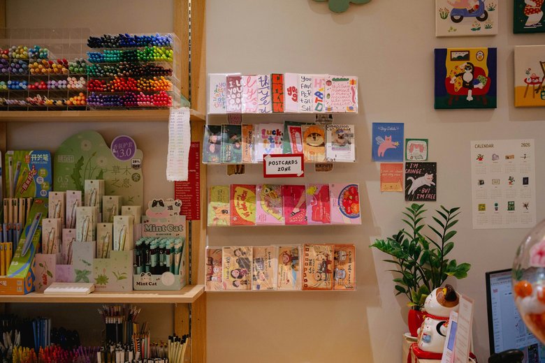 The interior of an independent stationery shop, with cards and pens arranged across the display units.