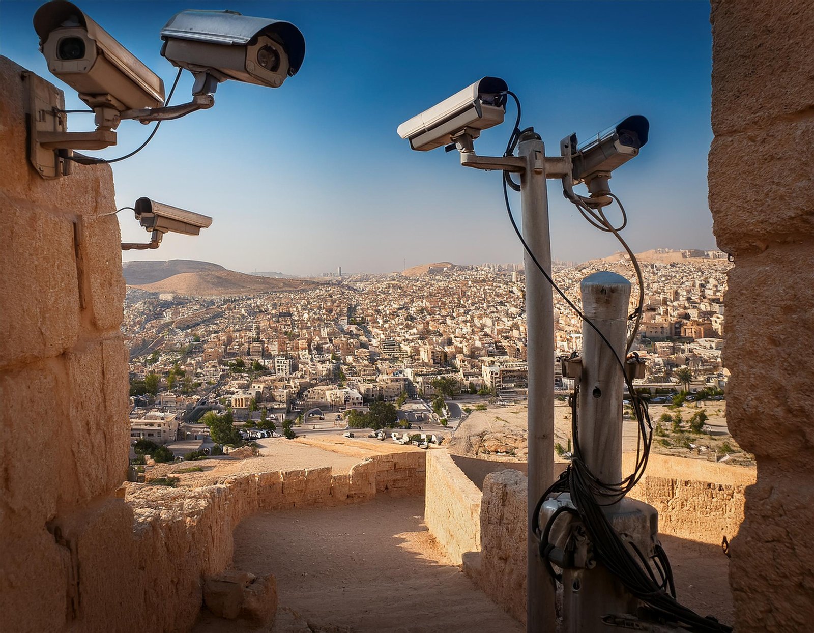 Palestinian city under Israeli surveillance cameras. Generated with Adobe Firefly.