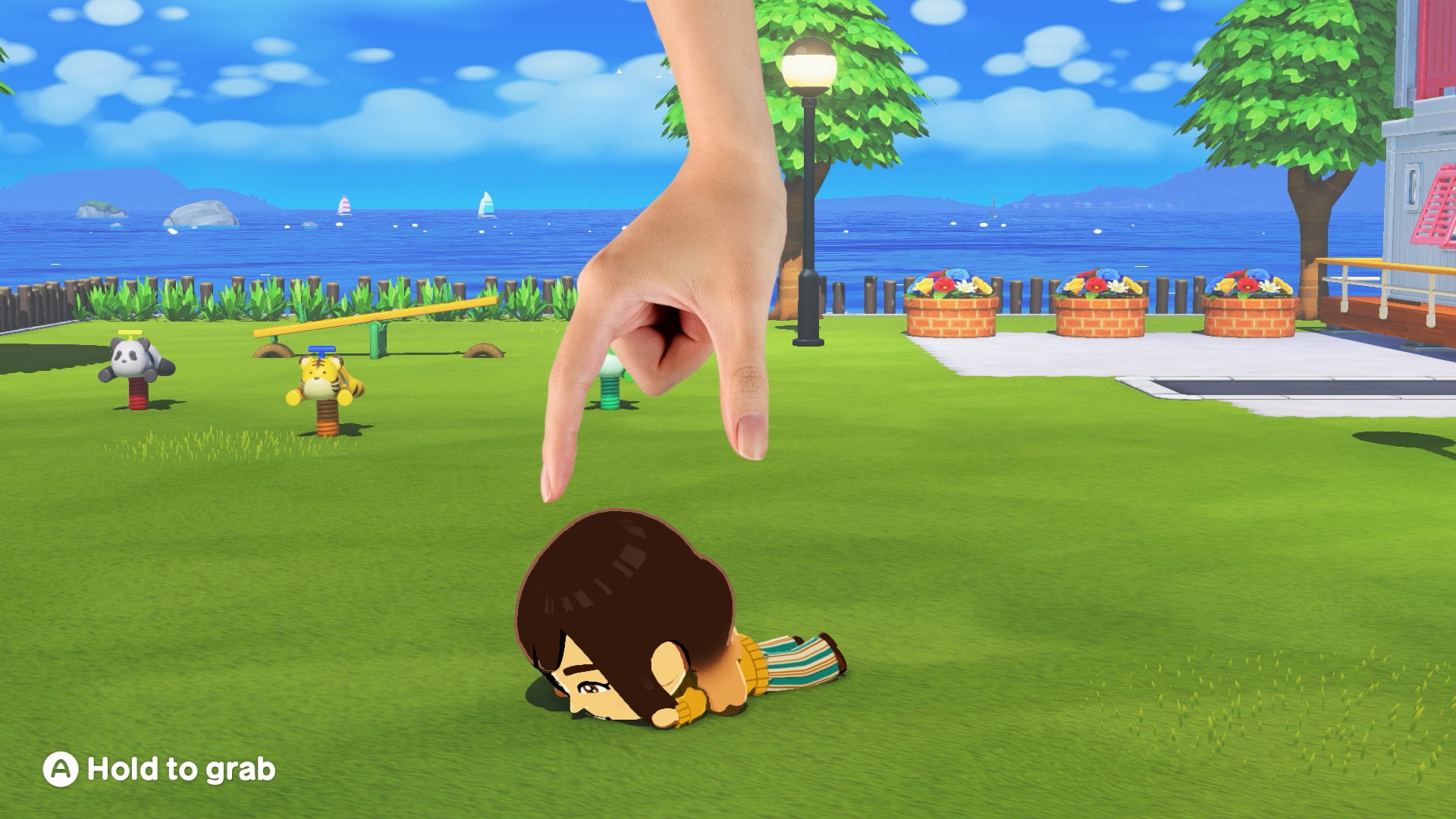 Un Mii affalé sur la pelouse que le joueur s'apprête à relever dans Tomodachi Life : Une vie de rêve
