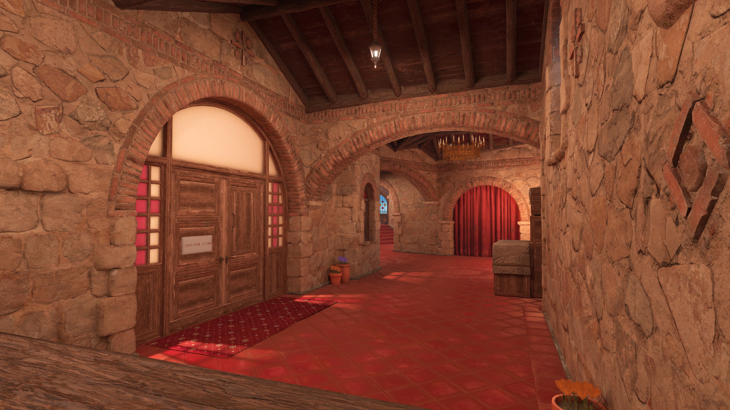 Couloir intérieur du monastère de Boulder dans Counter-Strike 2 : portes en bois, arcades de pierre et rideau rouge au fond