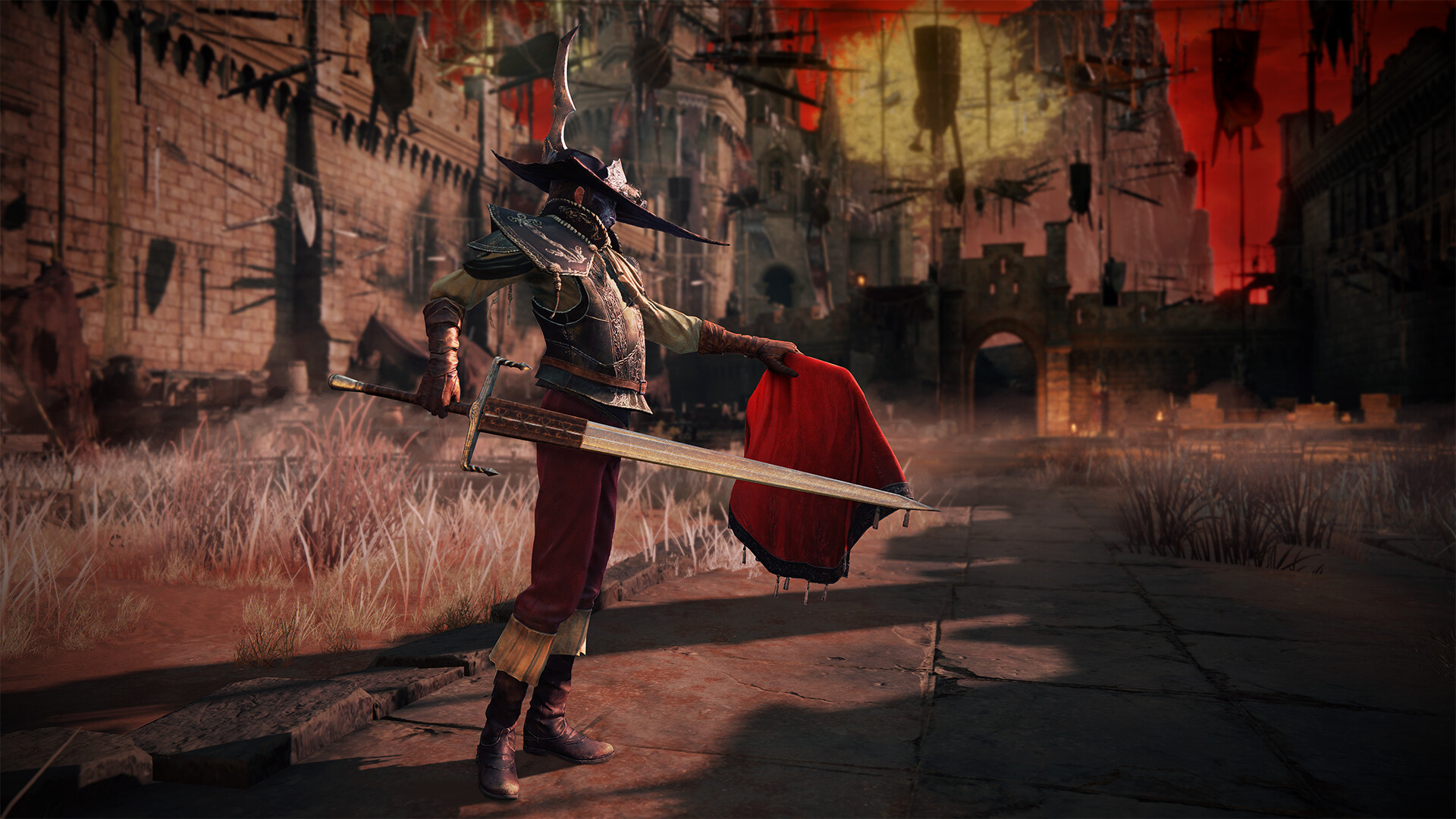Un personnage d'ELDEN RING coiffé d'un large chapeau pointu tient une épée longue d'une main et une étoffe rouge de l'autre, devant les remparts d'une forteresse en ruine sous un ciel rouge.