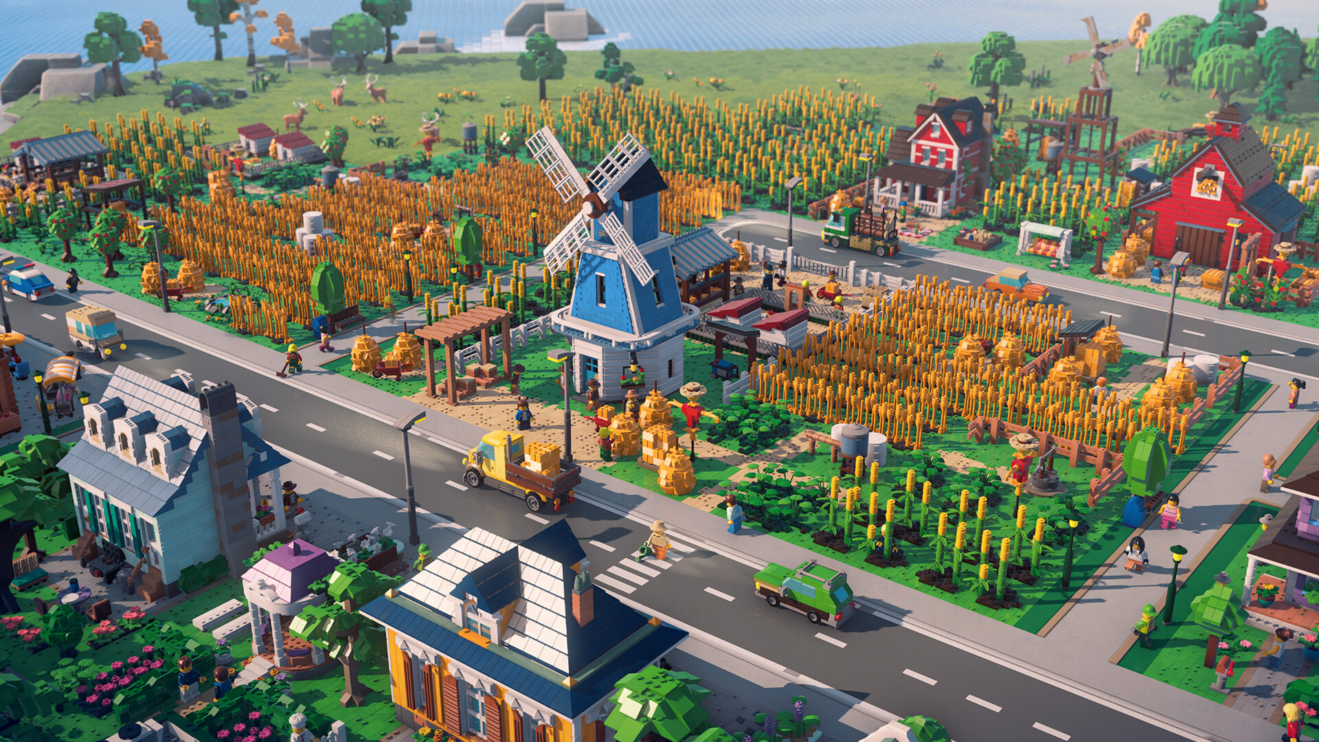 Champs de maïs, moulin à vent bleu et granges rouges en briques LEGO, traversés par une route où roule un camion jaune.