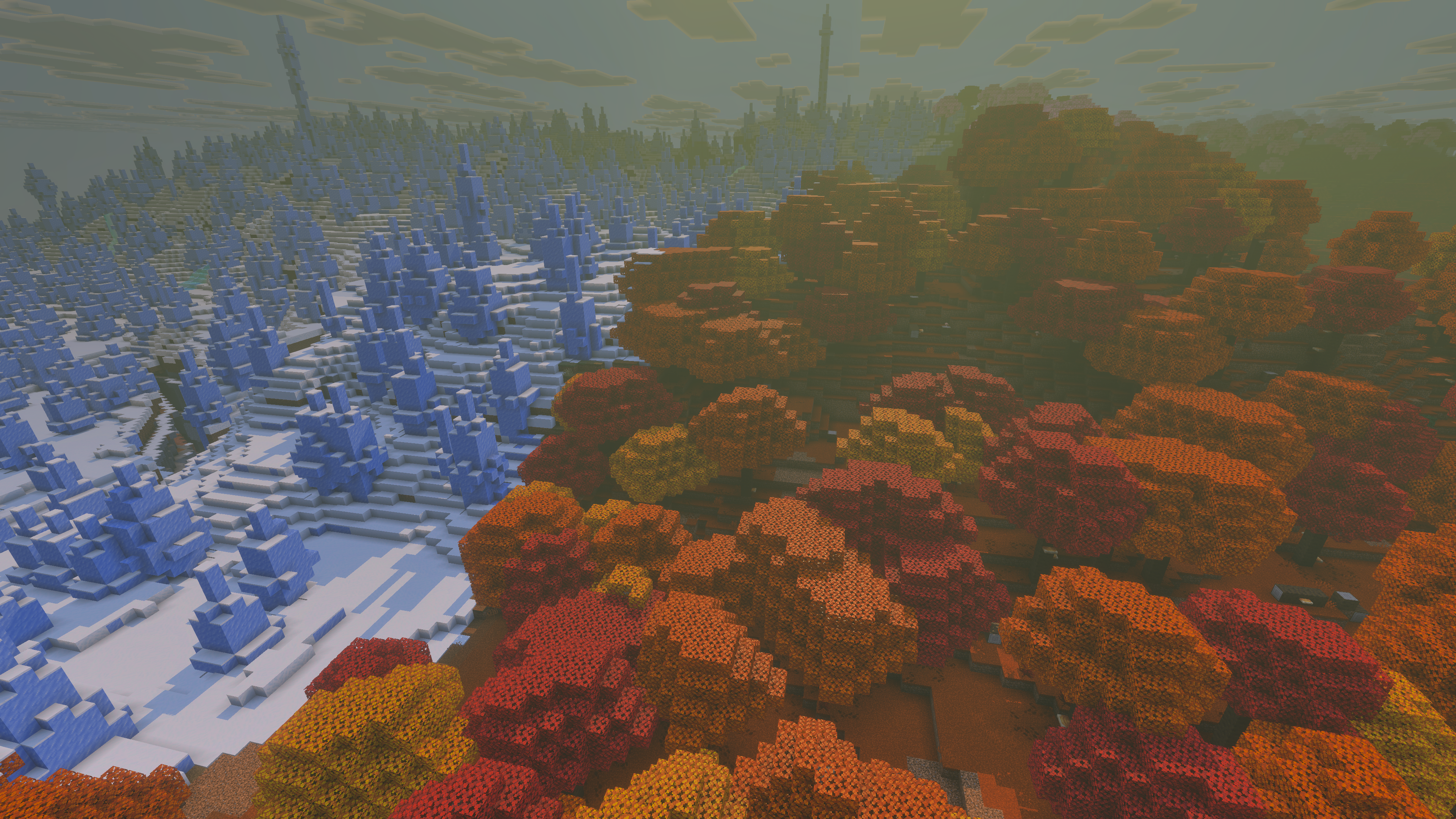 Une Forêt ambrée aux arbres orange et rouges jouxtant un biome de Stalagmites de glace dans Minecraft 26.3