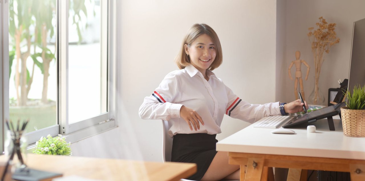 Blog - Top 10 Steps to Lift the Mood - An employee working at her desk